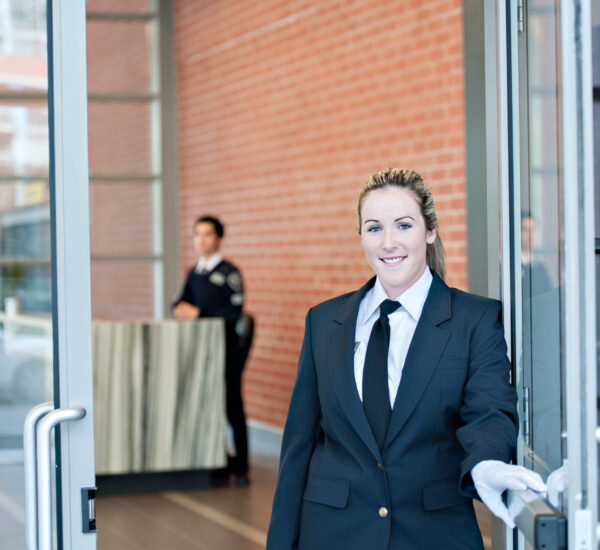 Female concierge opening door