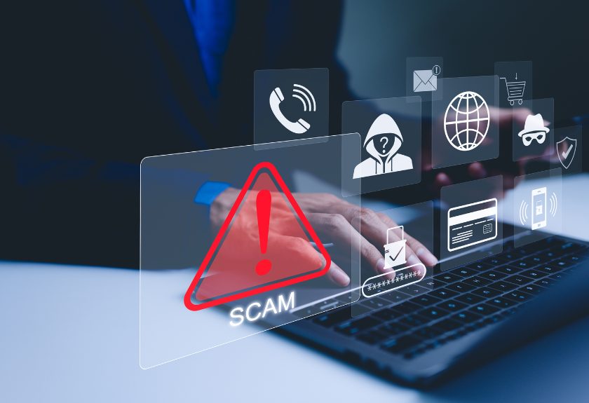 hands at a laptop with malicious icons emerging