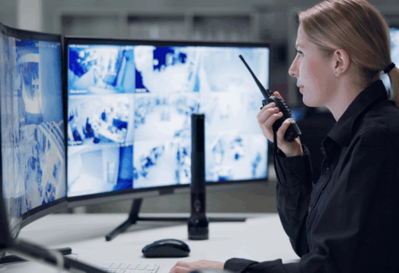 security guard at a command post radioing to another on the ground guard