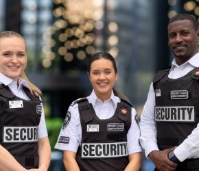 three tactical seurity guards in the courtyard of an institution