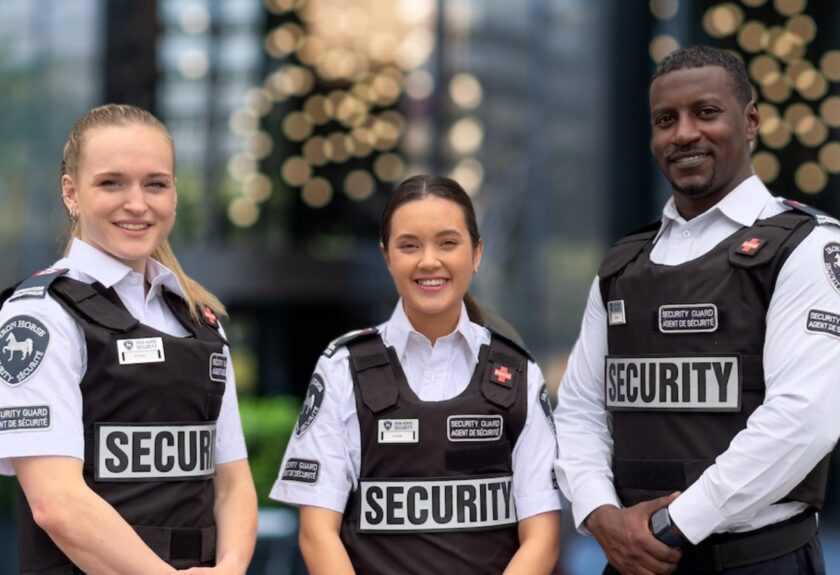 three tactical seurity guards in the courtyard of an institution