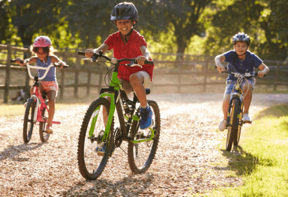 Bub and birdie - kids enjying a bike rie ona country road during summer vacation