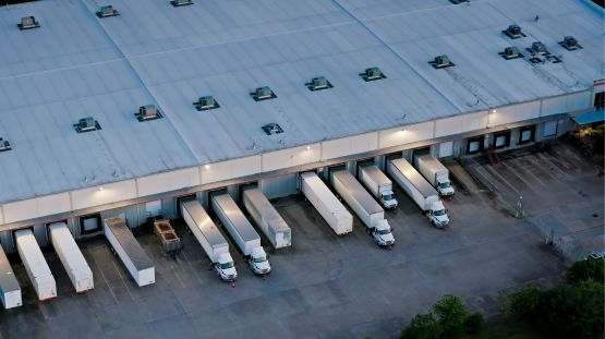 transport trucks at the loading dock of a facility