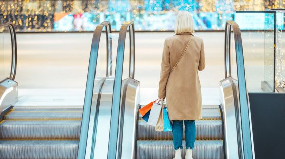 woman riding the elevator at a retail shopping mall