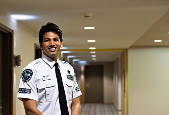 male iron horse security guard in the hallway of a residence building
