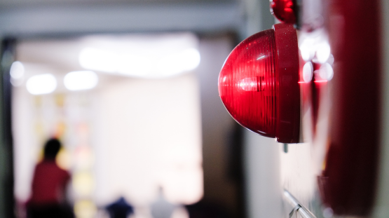 an alarm flashing and a person in the background