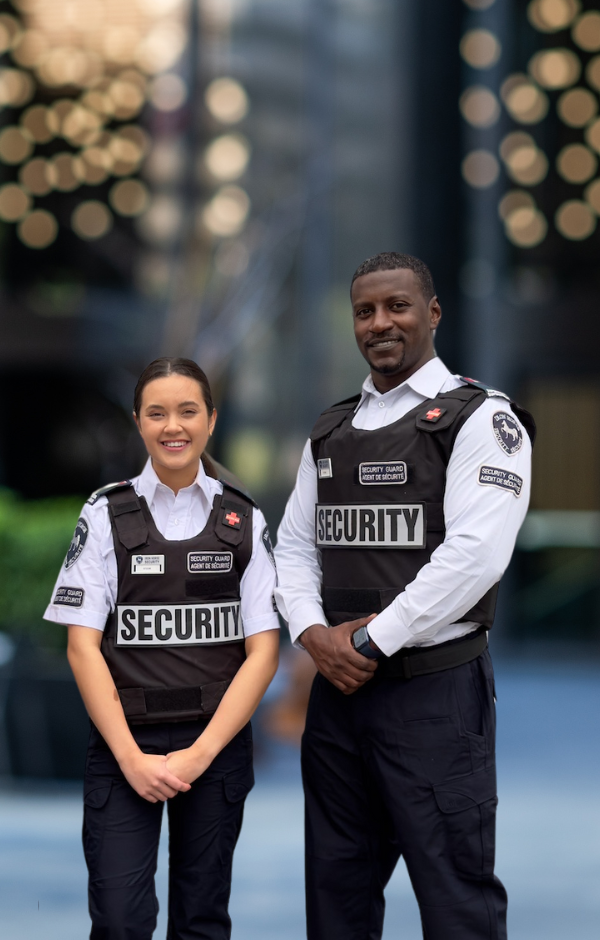 a male and female iron horse security guard in the courtyard of a commercial building